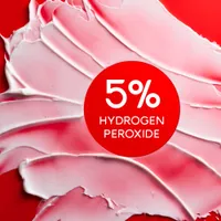 Colgate Optic White Pro Series Stain Prevention Whitening Toothpaste smeared on a red background. In text: 5% hydrogen peroxide.
