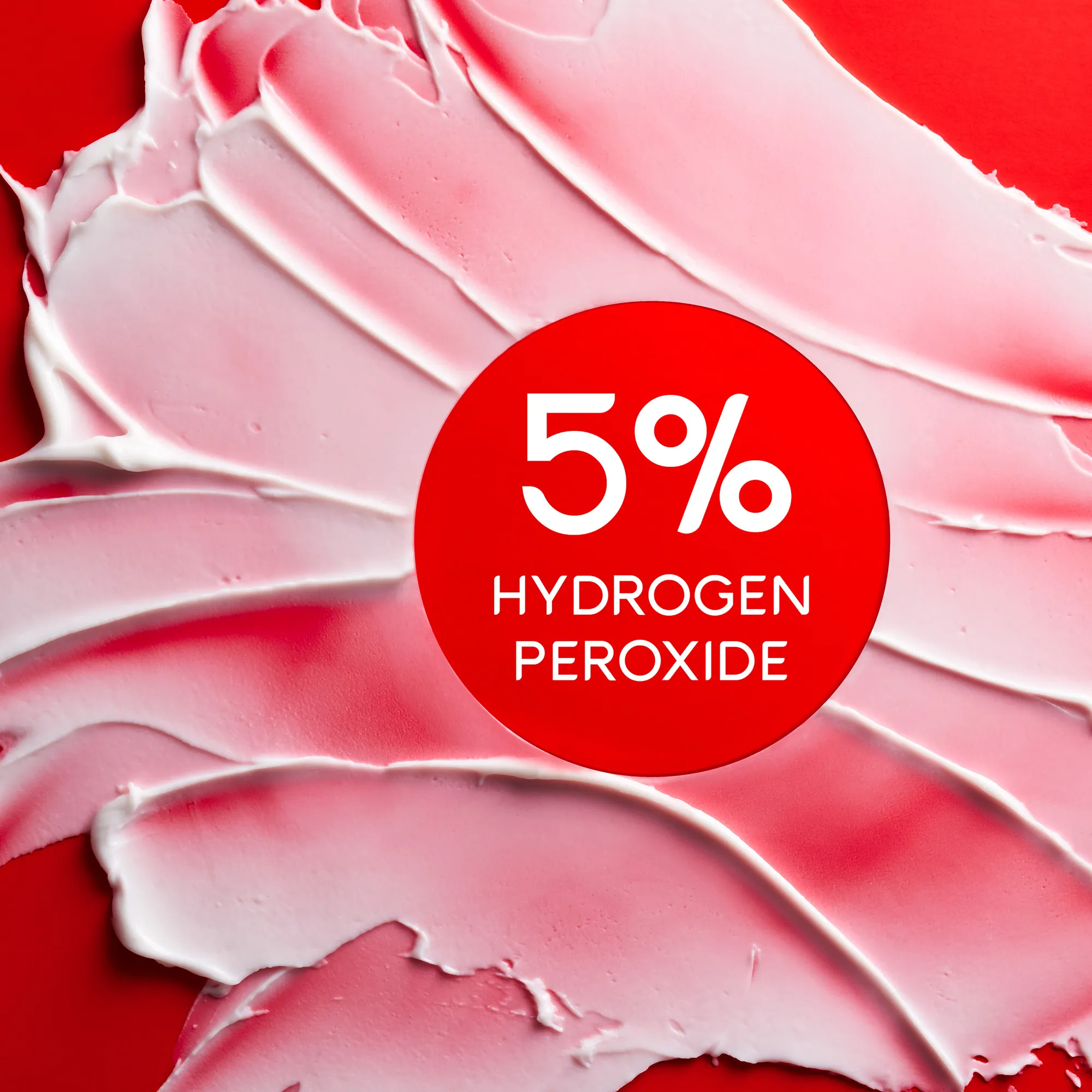 Colgate Optic White Pro Series Stain Prevention Whitening Toothpaste smeared on a red background. In text: 5% hydrogen peroxide.
