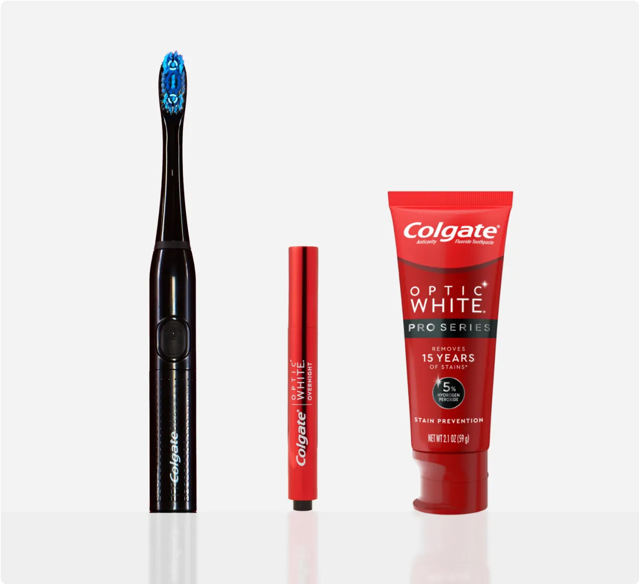 The Optic White Pro Series Powered Toothbrush, Optic White Overnight Teeth Whitening Pen and Optic White Pro Series Whitening Toothpaste side by side