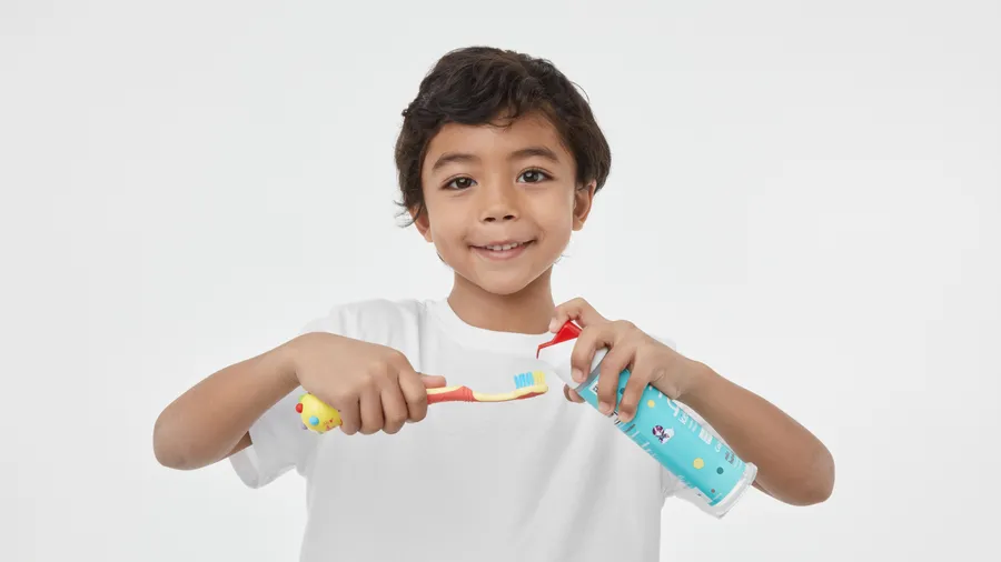 boy showing how to use hum kids smart manual coral toothbrush