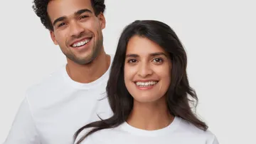 man and a woman smiling brightly next to each other