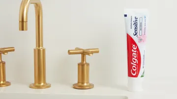 colgate maximum strength  sensitive whitening anticavity toothpaste on the sink