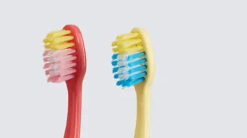 coral red and yellow colgate hum smart manual replacement brushes