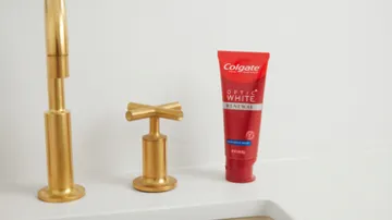 colgate optic white renewal toothpaste on the sink