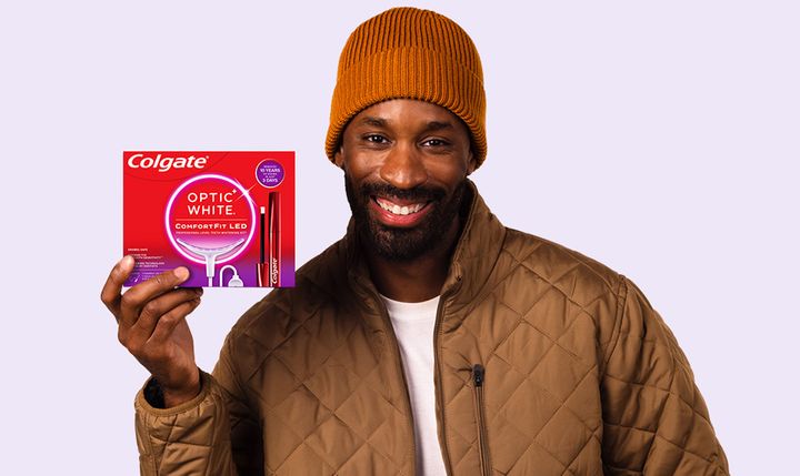 A man holding optic white comfortfit led kit and smiling