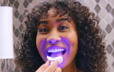 Woman using the optic white flexible LED whitening light